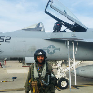 First Officer Courtland Savage in front of an F/A-18, Founder of Fly for the Culture (NPO)