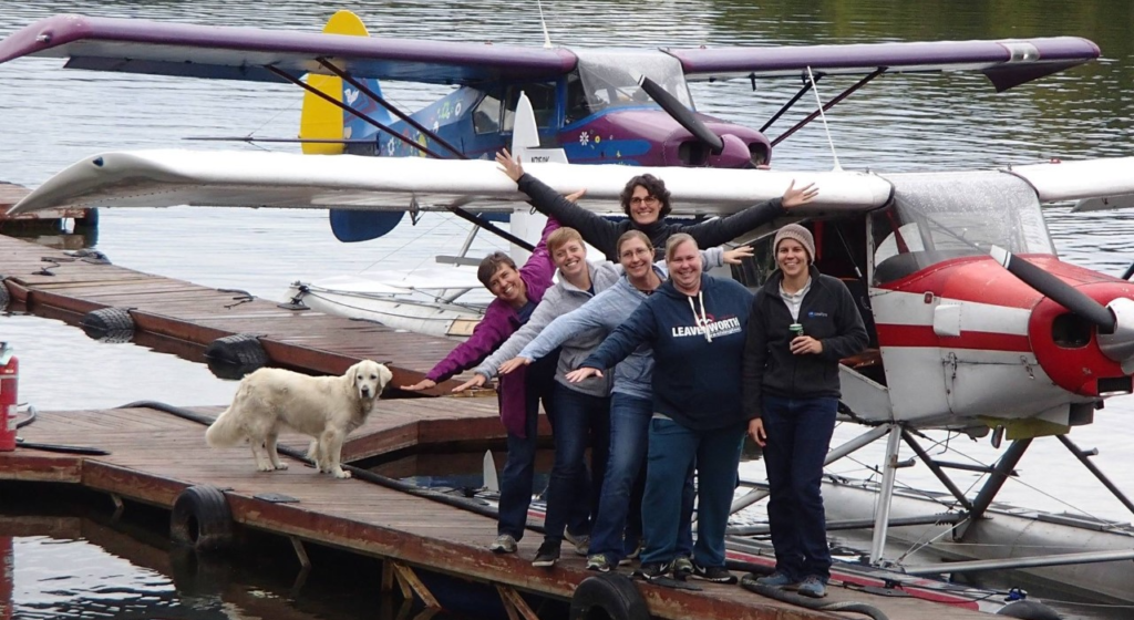 People in front of water float aircraft