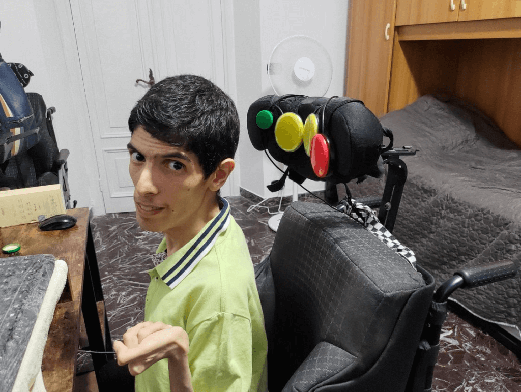 Lillo sits in his chair with custom button inputs that allow him to control Microsoft Flight Simulator with only head movements