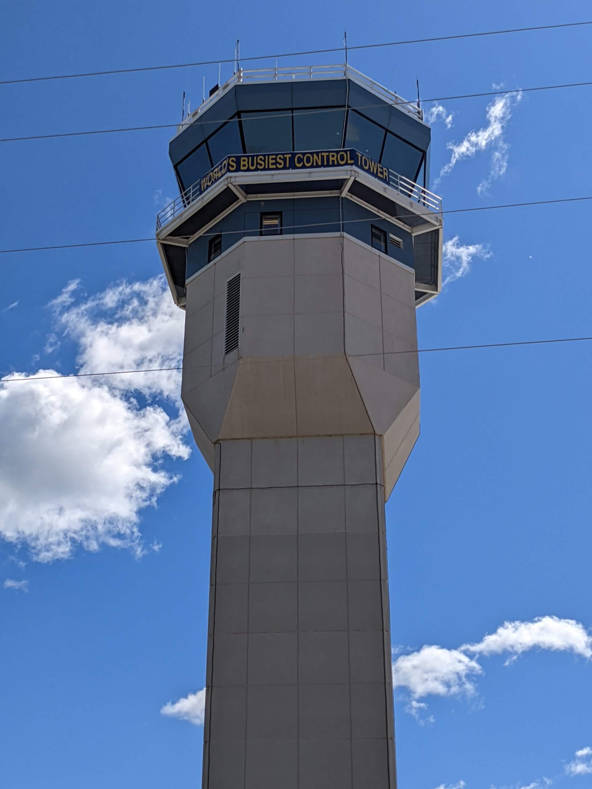 The air traffic control tower at Oshkosh with a banner that reads "World's Busiest Control Tower"