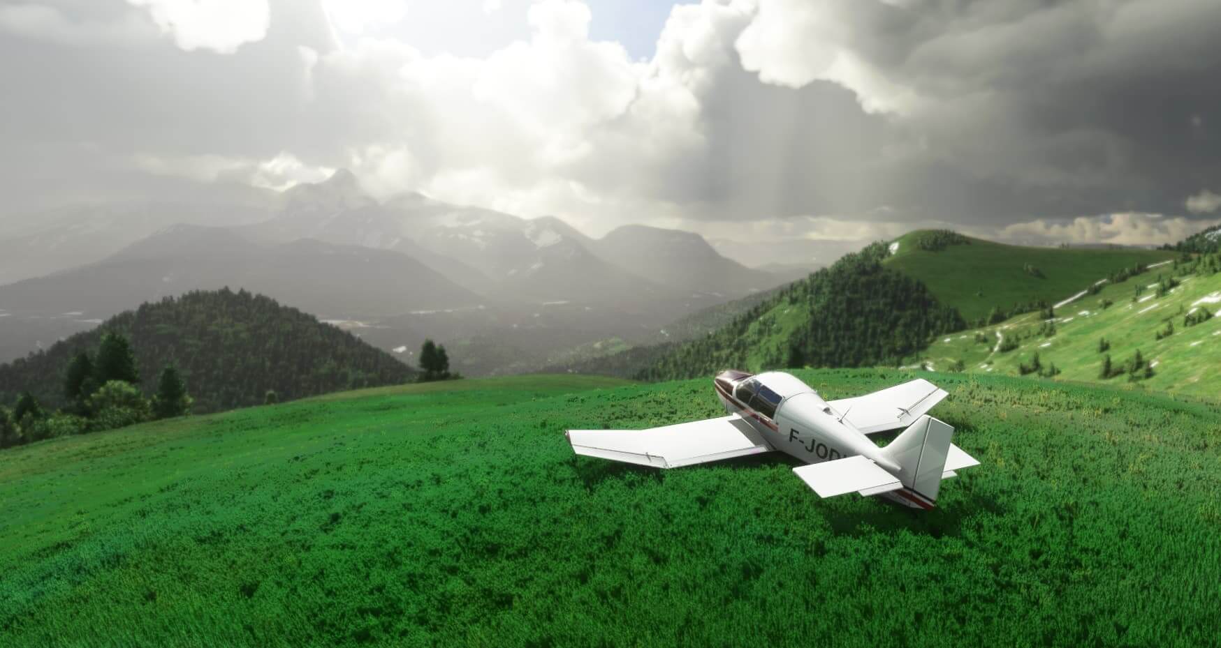 Small aircraft standing on top of a grassy hill overlooking the mountains