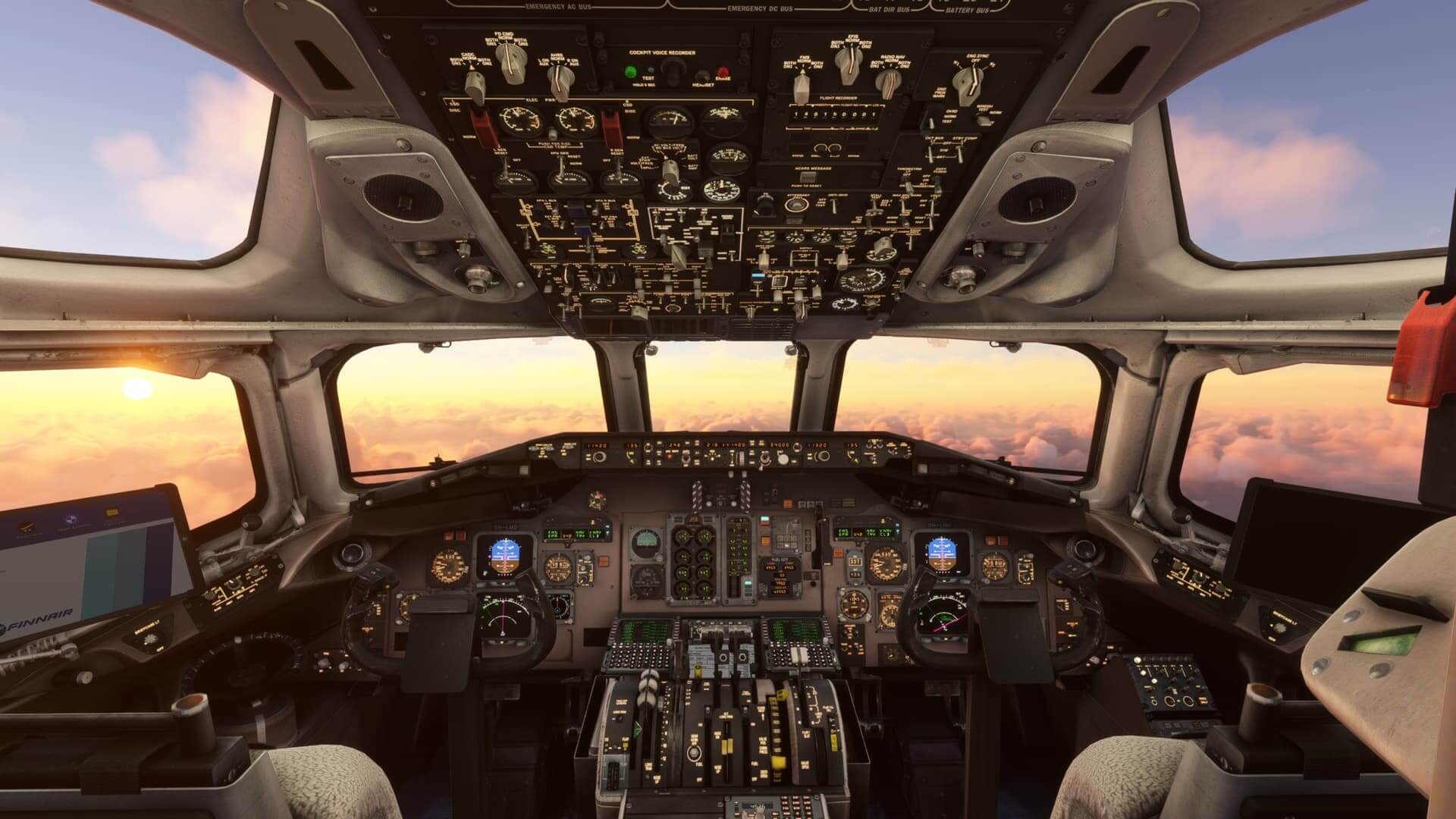 An image of the cockpit of a plane, with the sunrise visible outside the windows.