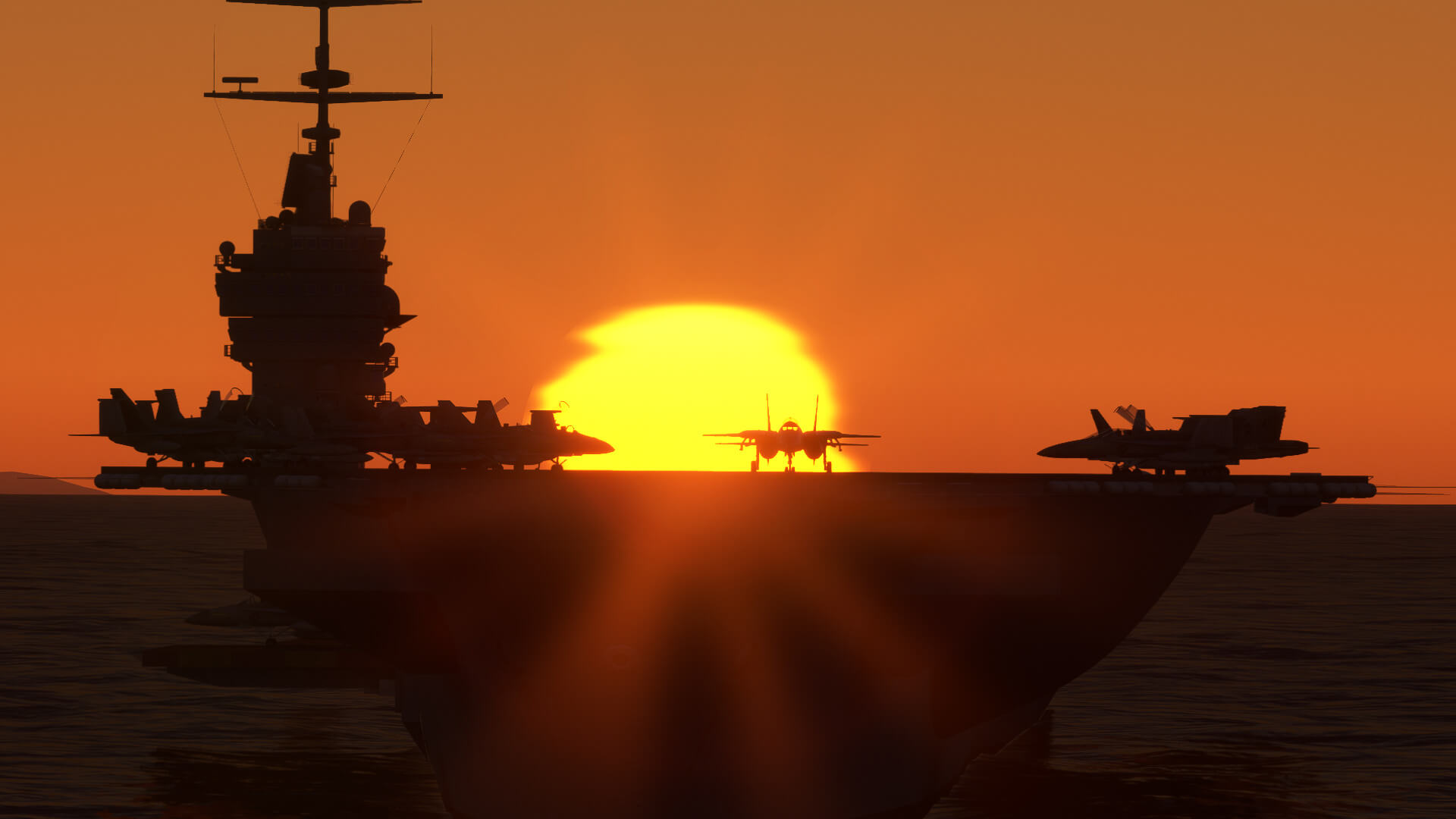 Several jets are silhouetted on an aircraft carrier by the setting sun.