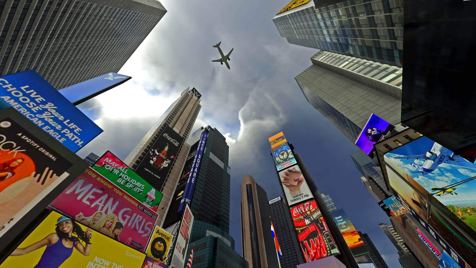 A bottom-up view of an airliner flying over Times Square in New York. Many brightly colored billboards on the sides of buildings are visible.