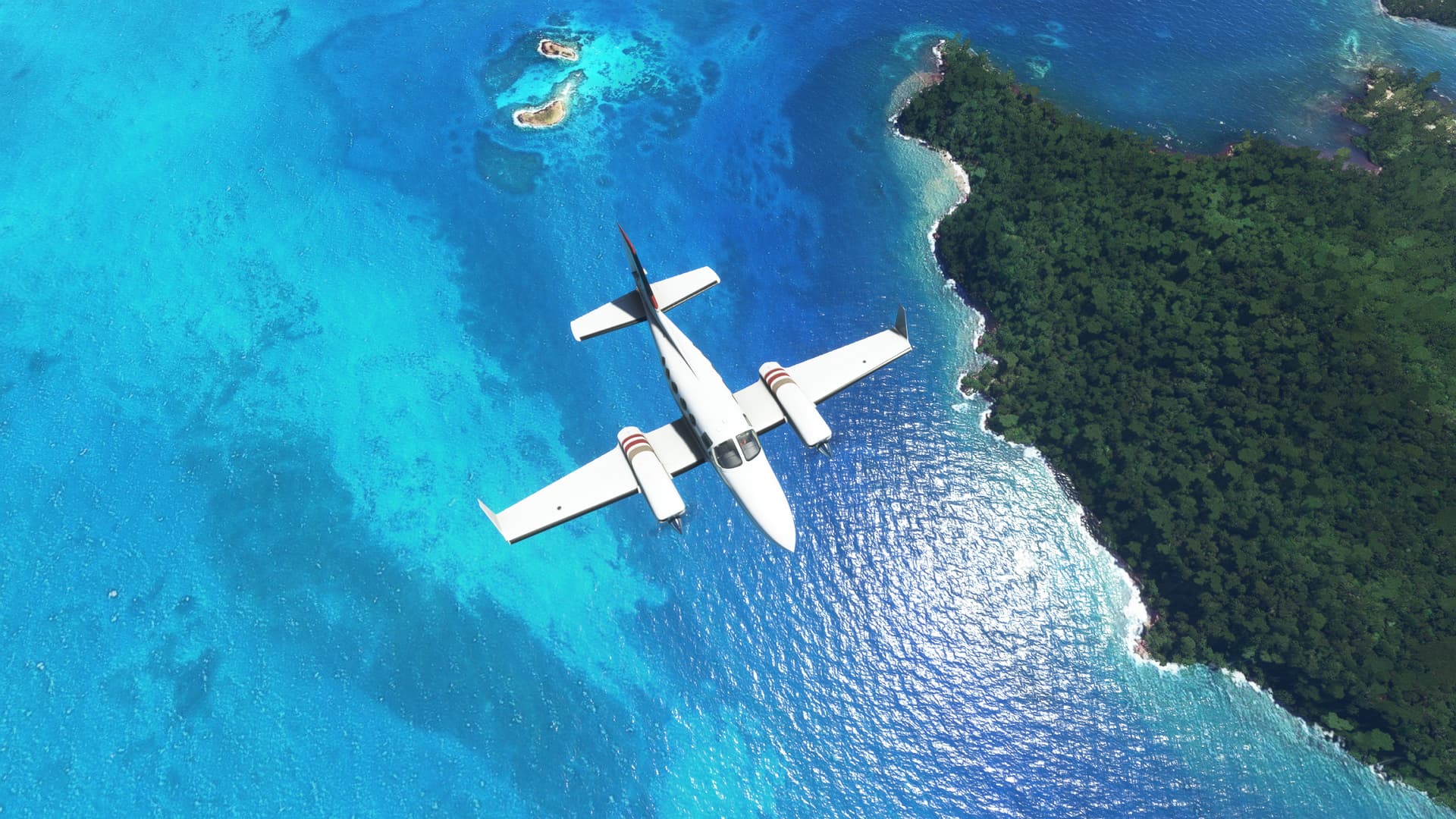 Top down view of a twin-engine GA plane flying over a shoreline. There are green trees visible on the landmass, and the water is bright blue.