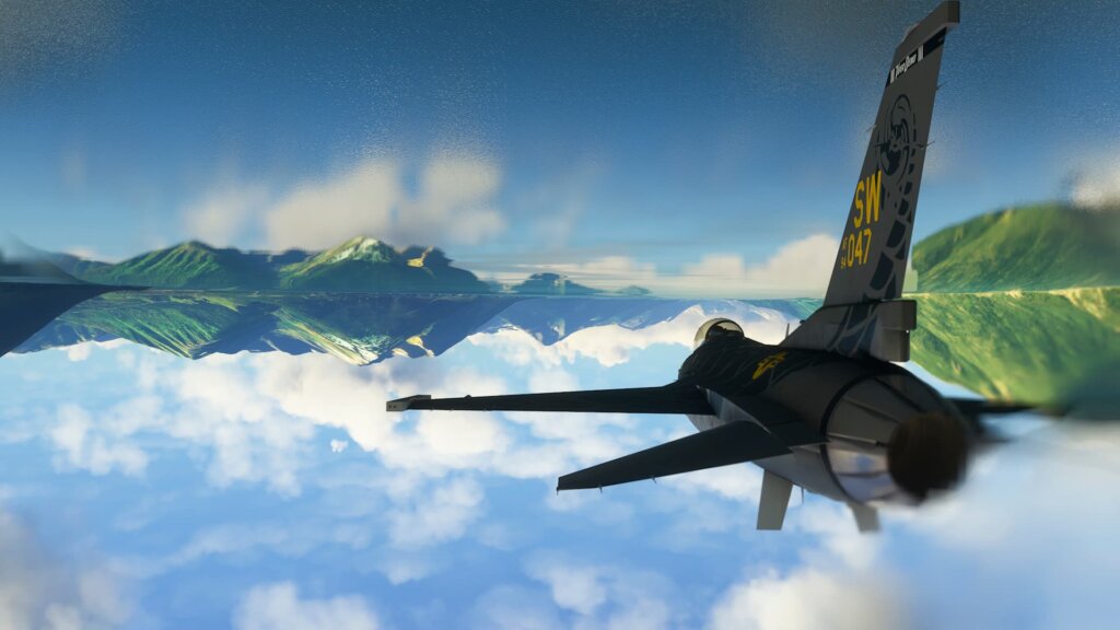 An F-16 Fighting Falcon flies inverted above water. Clouds and mountains are reflected on the water's surface. The screenshot is flipped upside down so the sky is at the bottom and the reflective water is on the top.