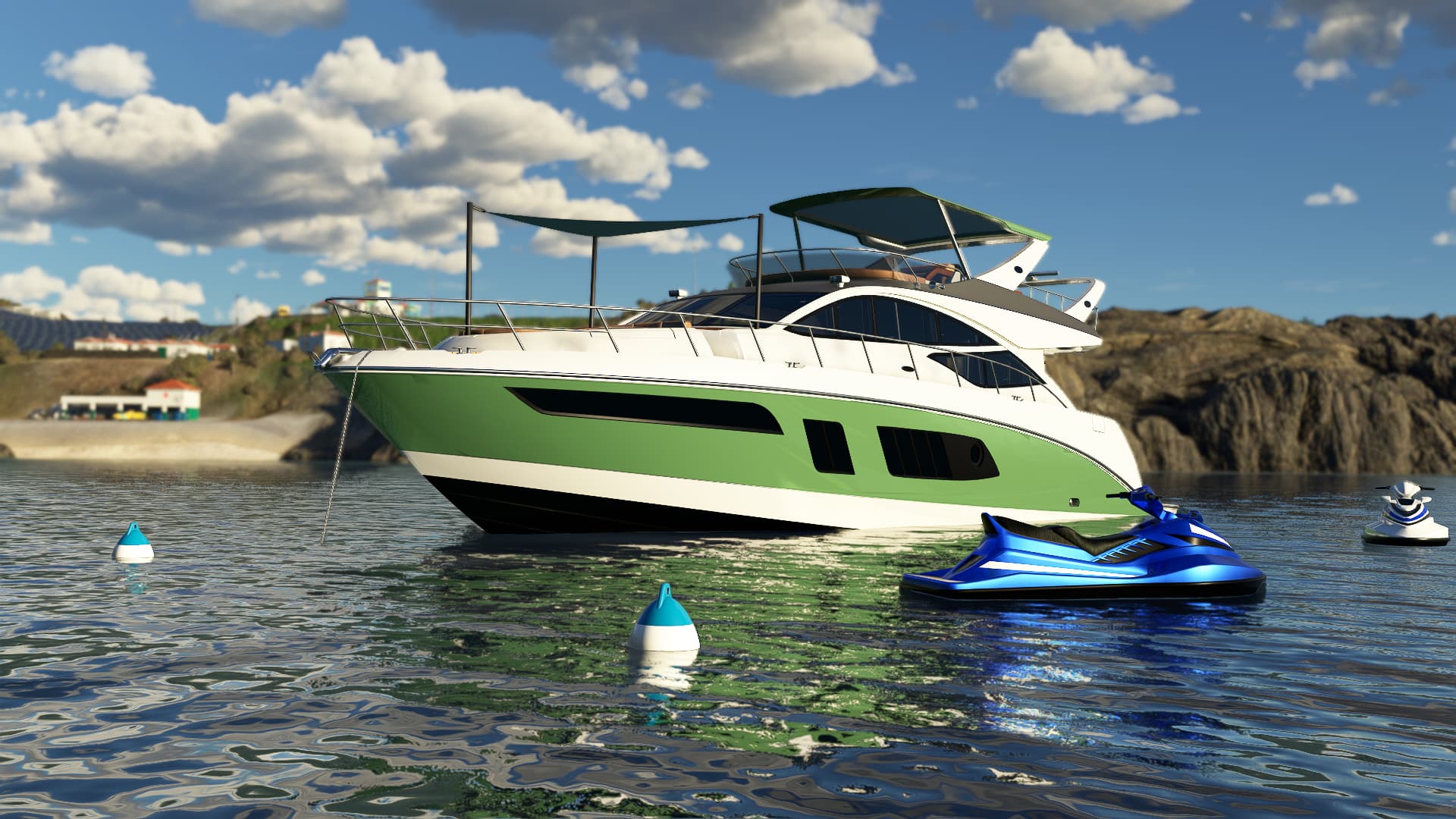 A white and green yacht and a blue personal water craft are docked next to a rocky shoreline.