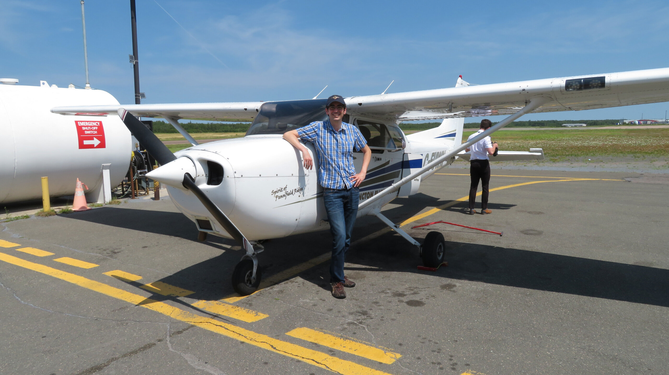 CaptArash stands next to a Cessna 172 on the flight line.