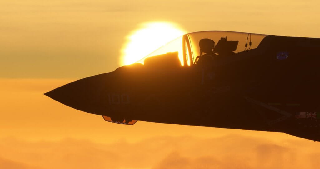 Close-up shot of the front of a Harrier jump jet in silhouette against a bright yellow sun.