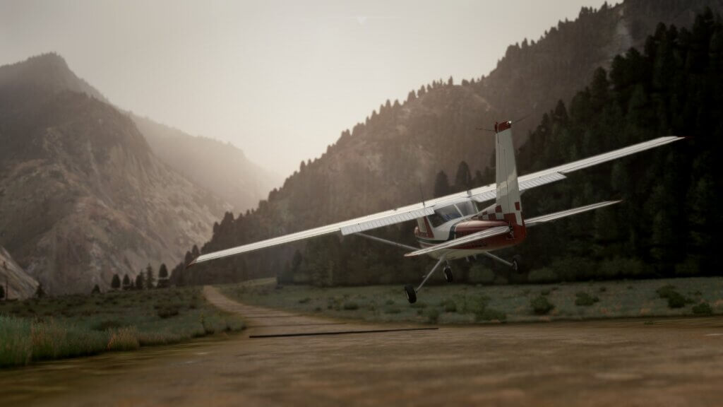 A Cessna 142 about to touch down on a small dirt strip in the mountains.