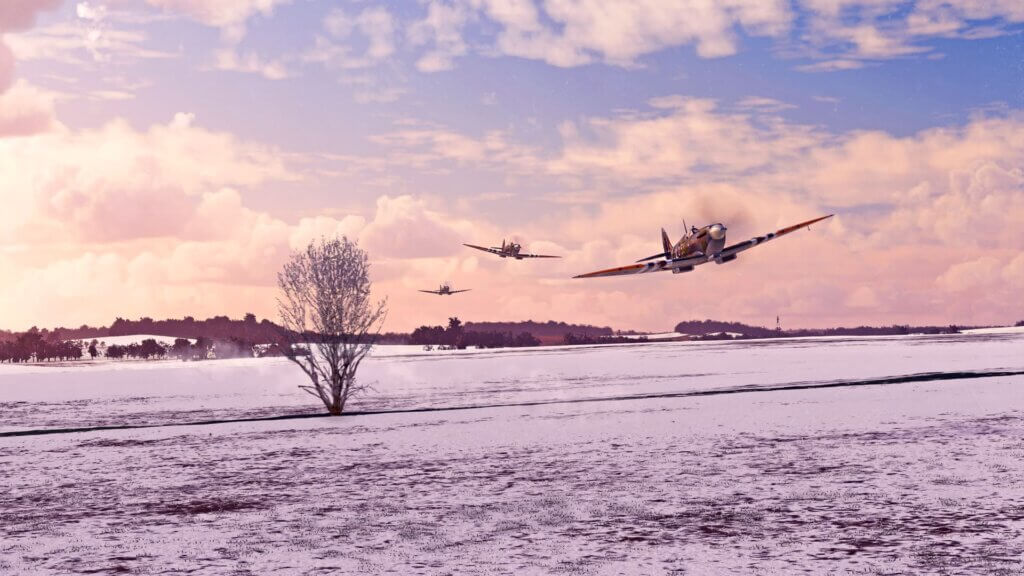 Three Supermarine Spitfires fly at low level in formation.