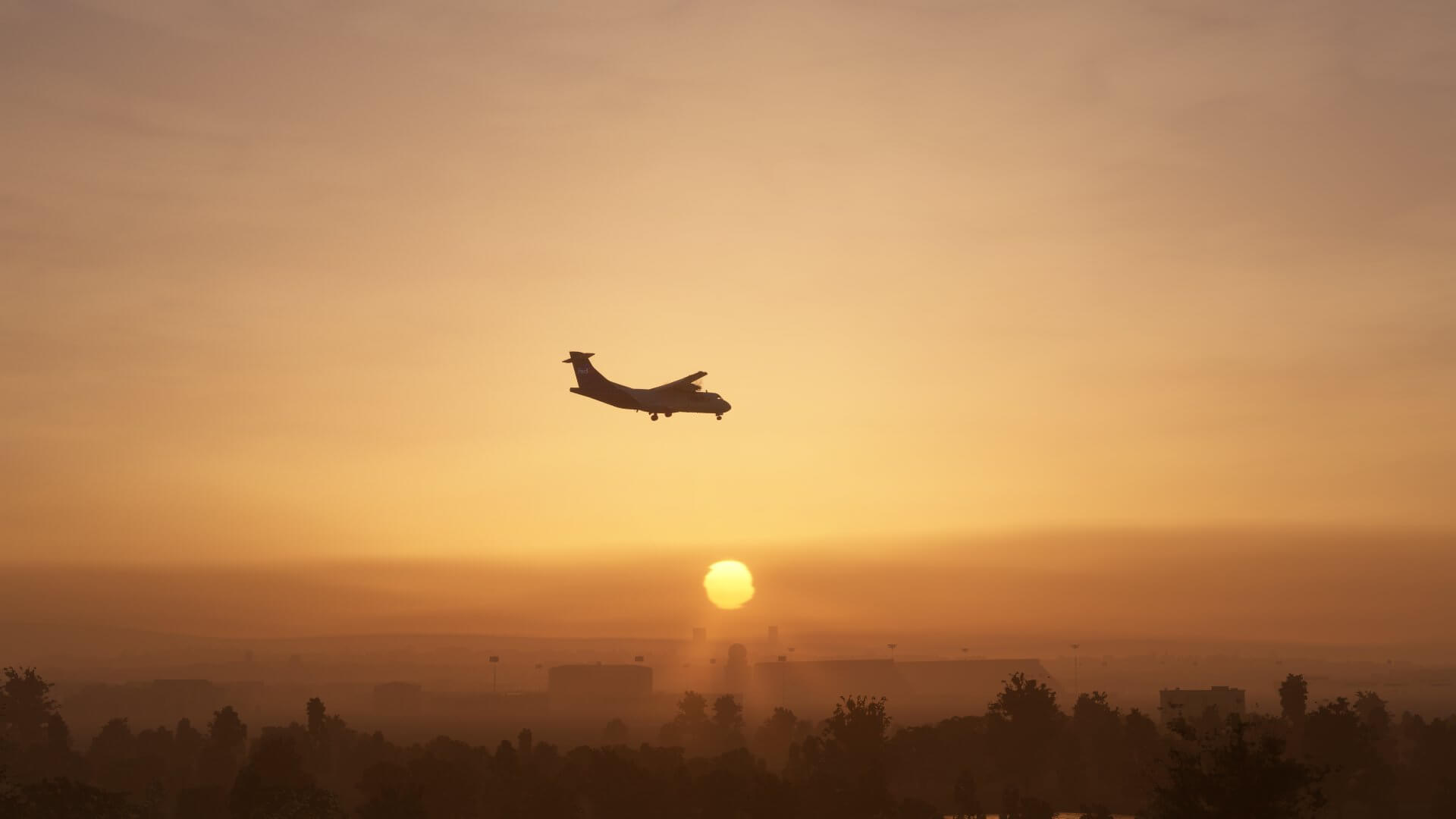 A FedEx ATR Cargo turboprop on approach with its landing gear down, and the sun setting behind it