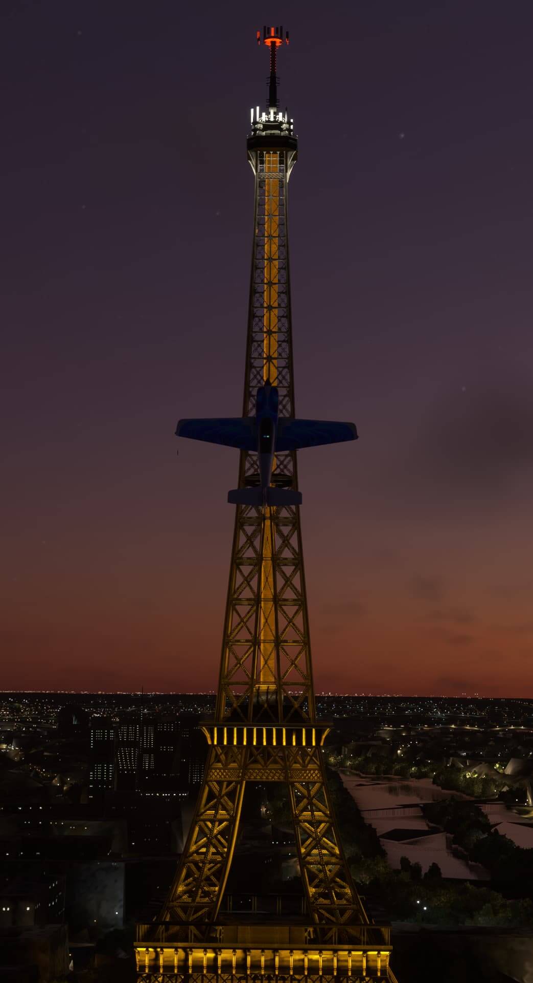 An Extra 300 aerobatic aircraft pulls up into the verticle with perfect alignment against the Eiffel Tower in the background.