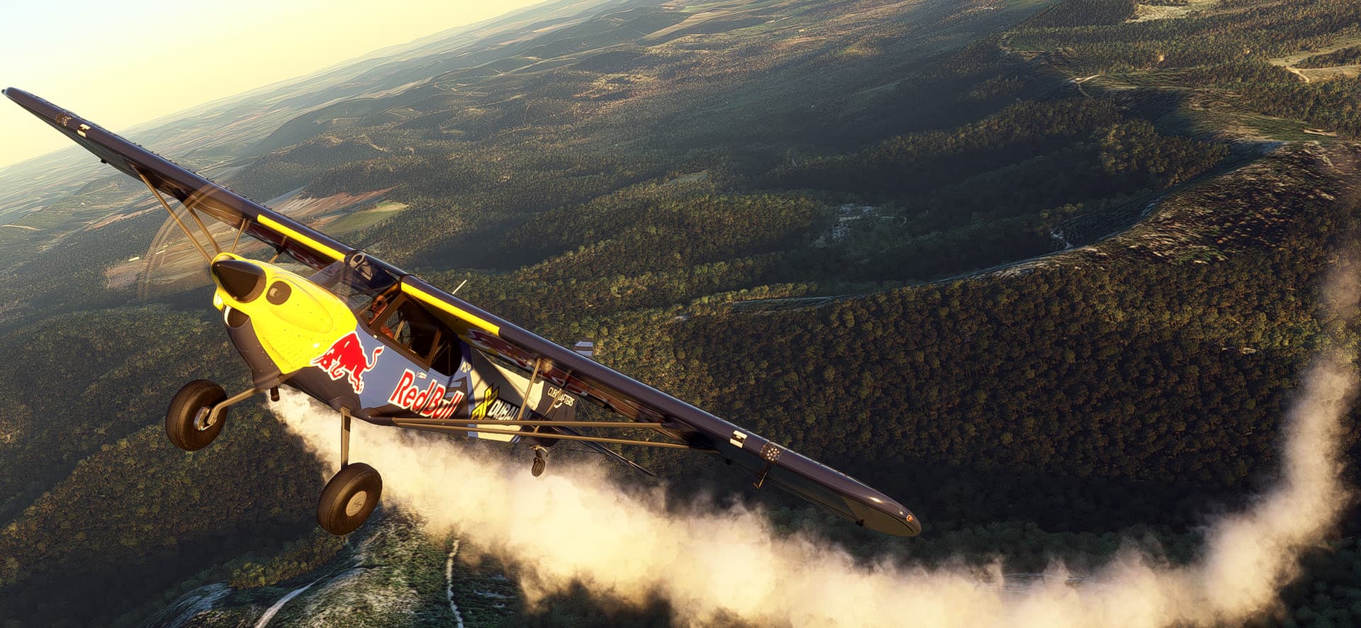 The Red Bull Carbon Cub pulls up away from terrain below with white smoke forming behind it.