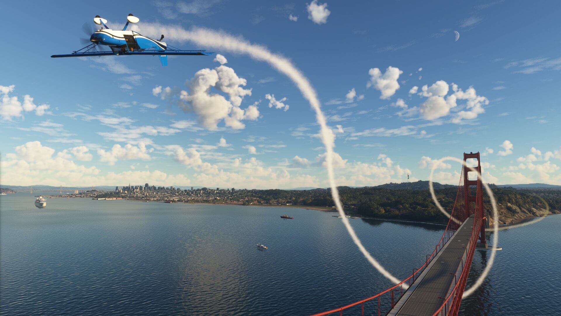 A small general aviation aircraft in blue paint scheme loops inverted above the Golden Gate Bridge, San Fransisco with white smoke pluming around the bridge behind.
