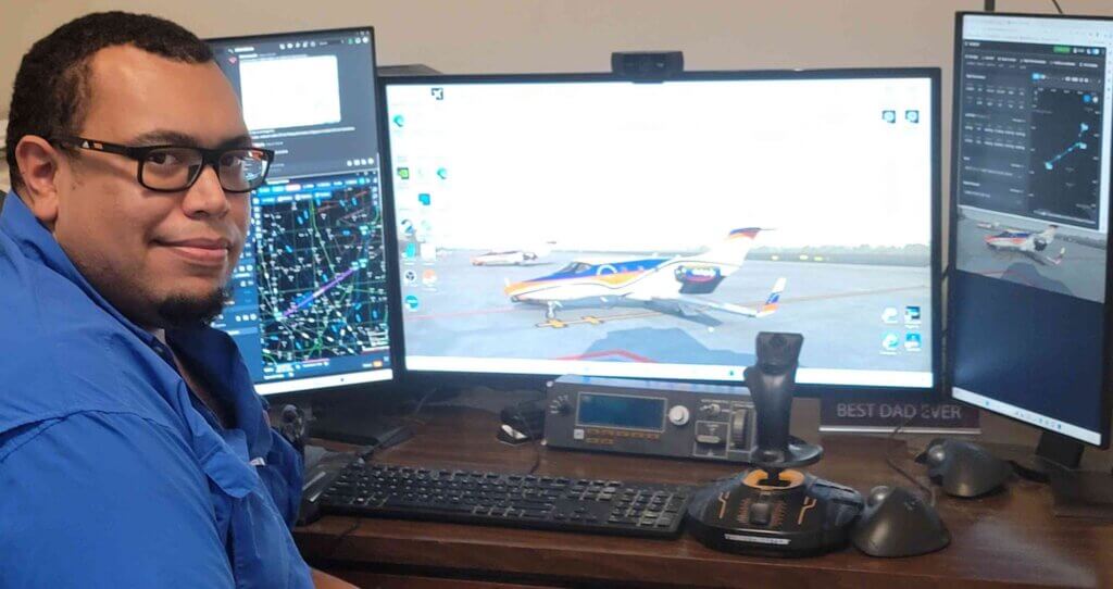 Nick Williams sits at his PC playing Microsoft Flight Simulator