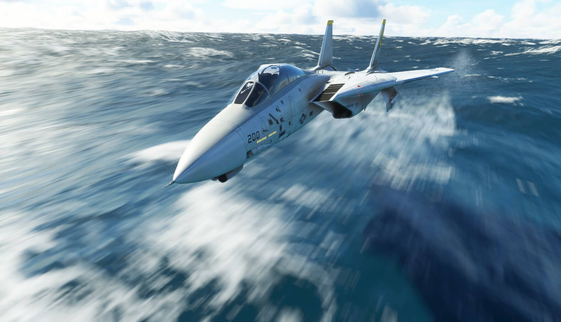 An F-14 Tomcat does a fast pass over rough ocean water.
