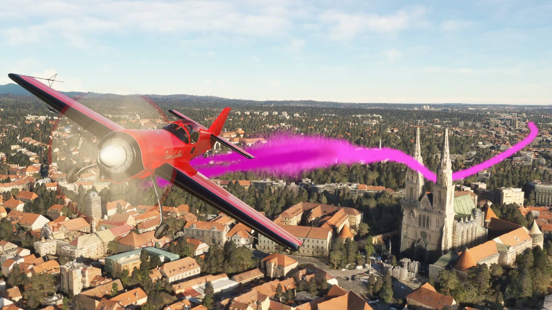 An aerobatic plane with pink smoke plumes through the spires of a Cathedral