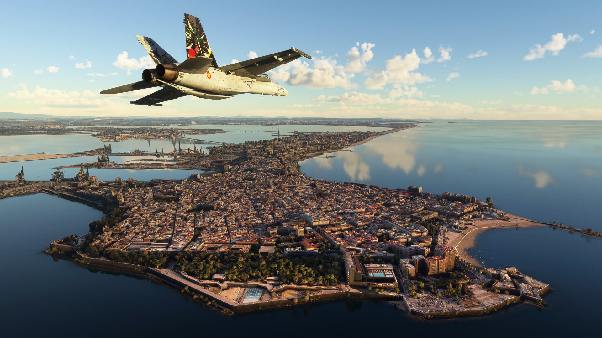 An F/A-18 passes over a city at low altitude