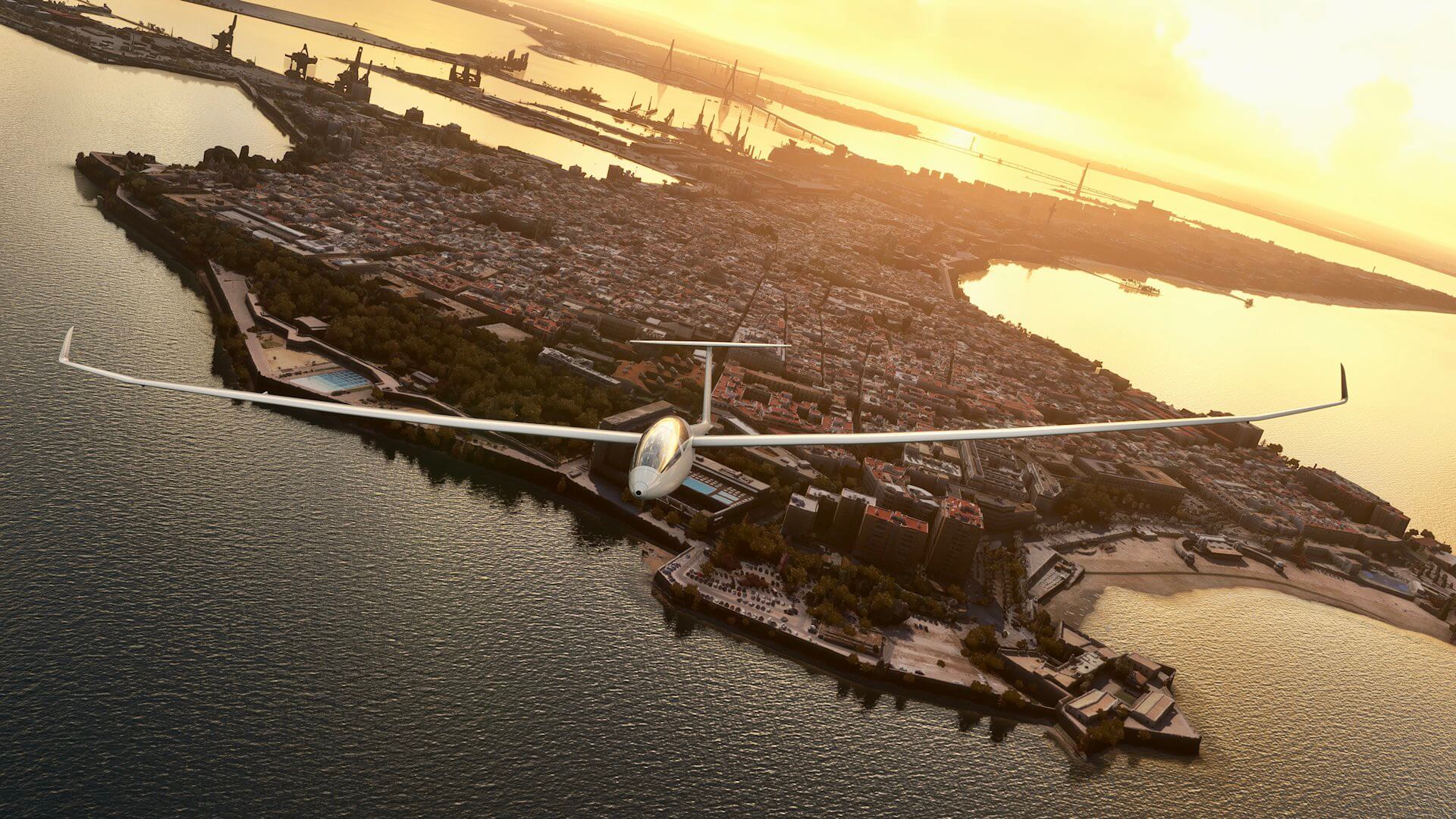 A glider banks right whilst flying away from a sunset in Cadiz, Spain