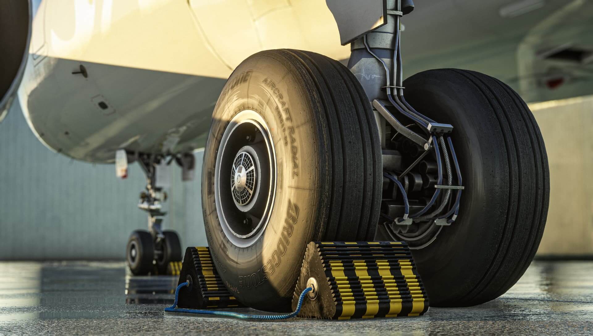 A close up shot of an airliners landing gear with chocks in place.
