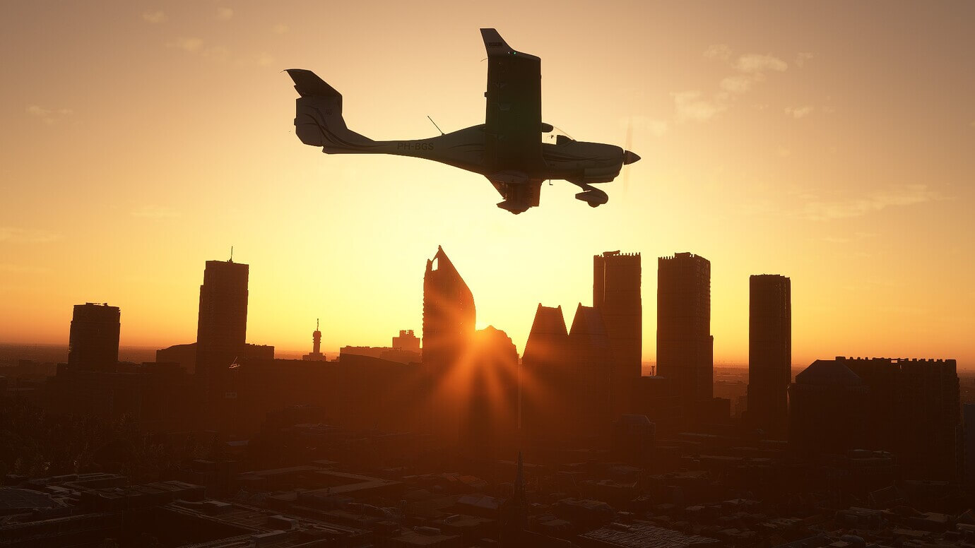 A GA aircraft passes a silhouetted cityscape