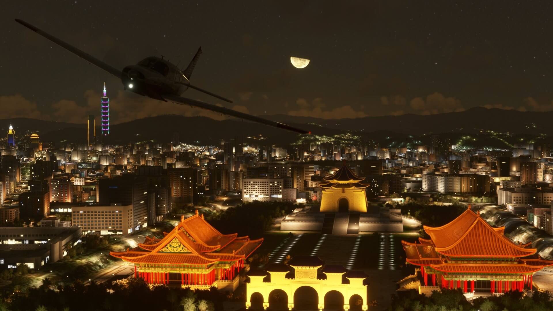 A low wing propeller aircraft flies above a Chinese temple at night.