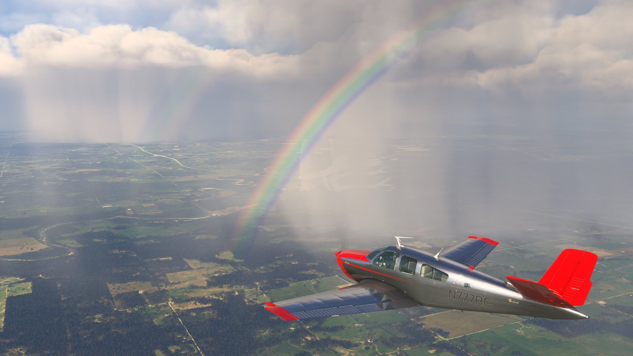 A propeller GA aircraft avoids rain ahead, with a rainbow in view.