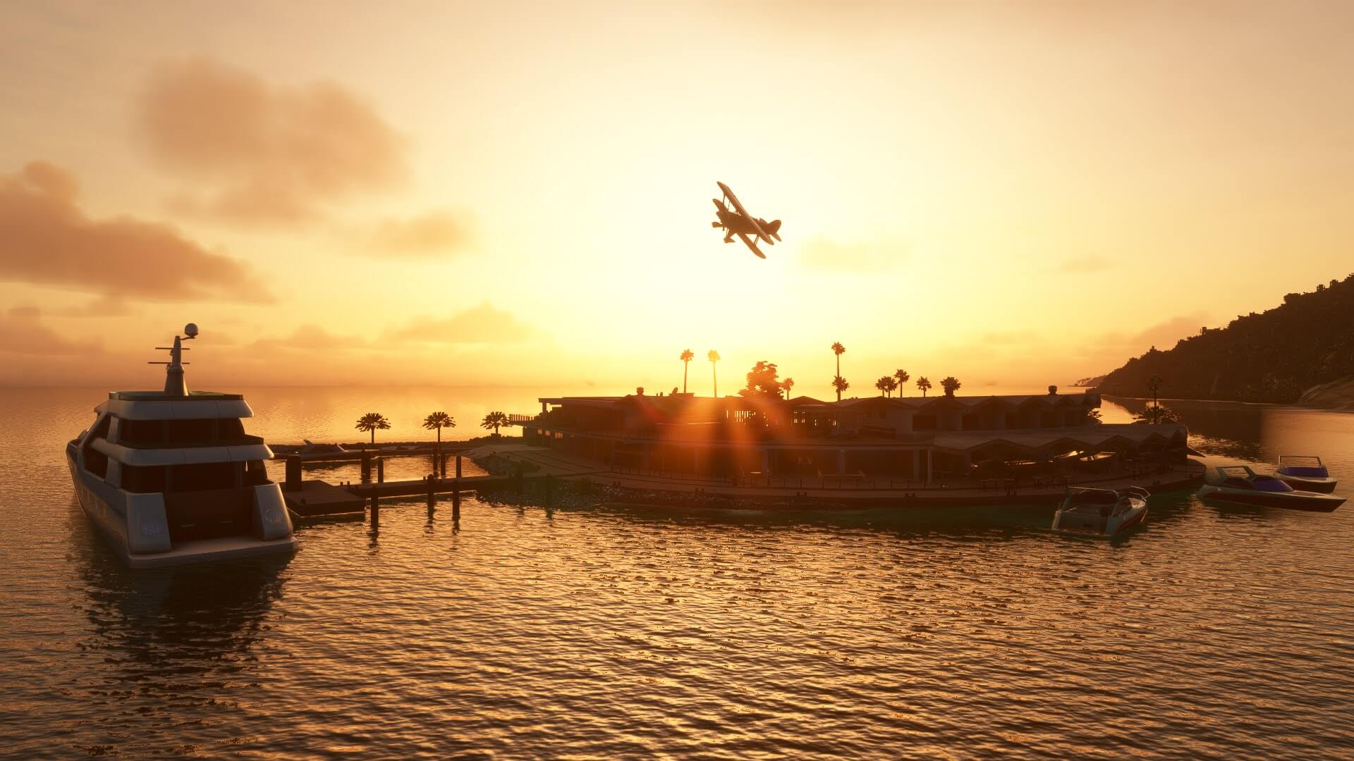 The silhouette of a bi-plane is cast with the sun behind as it overflies a private yacht parked on a marina.