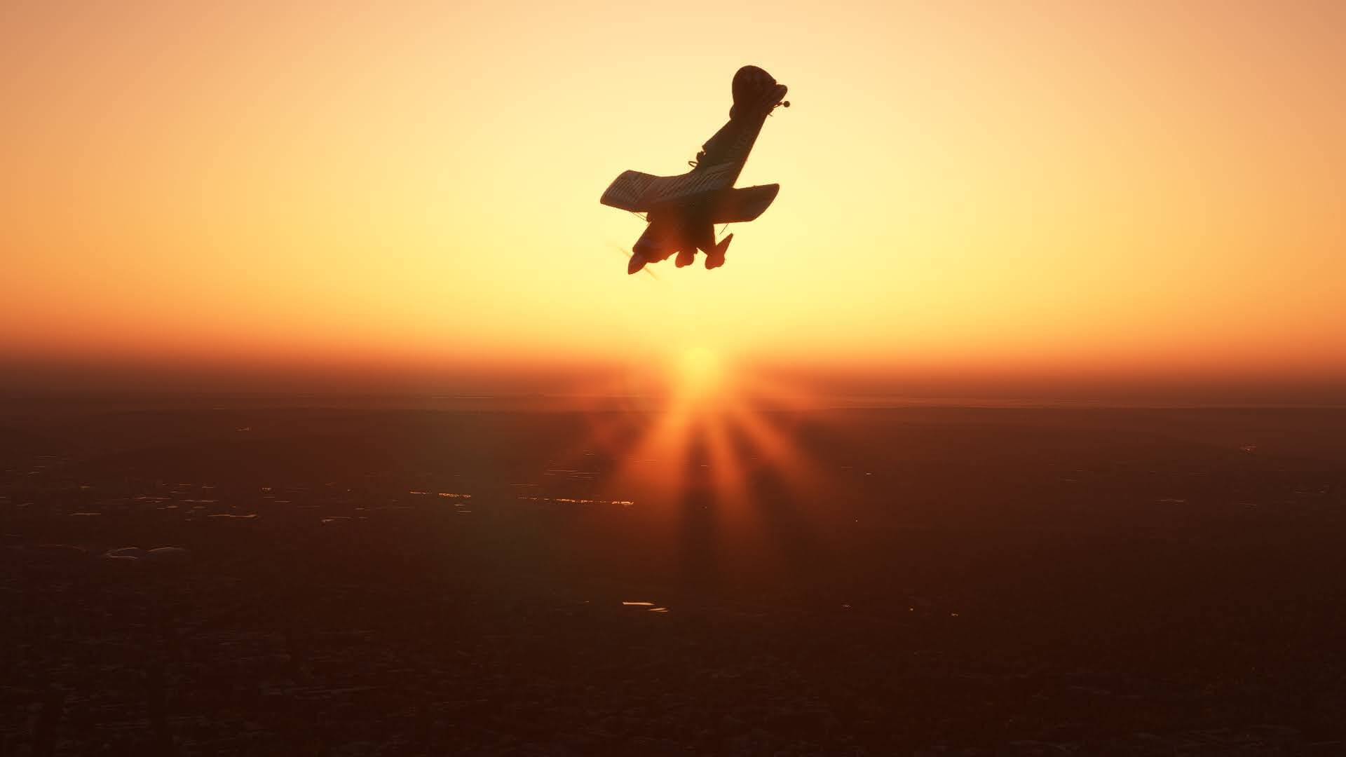 A bi-plane aircraft makes a steep dive with the sun setting on the horizon behind. 