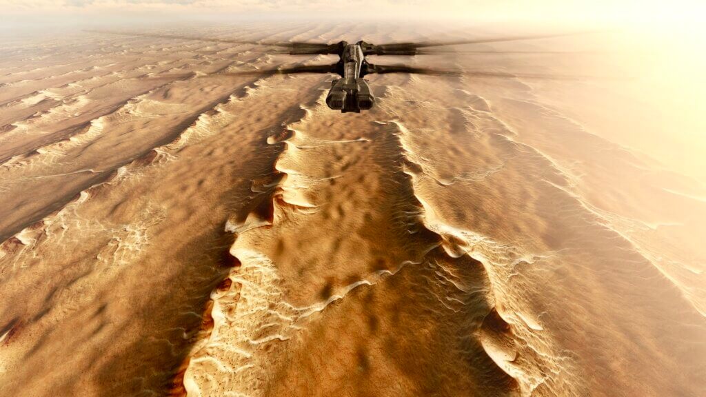 The Ornithopter cruises above the desert with wings unfolded.