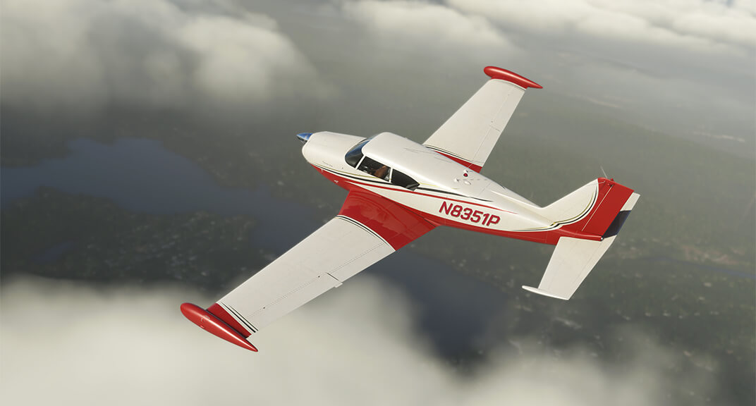 An A2A Comanche 250 with a red and white livery flies over clouds.