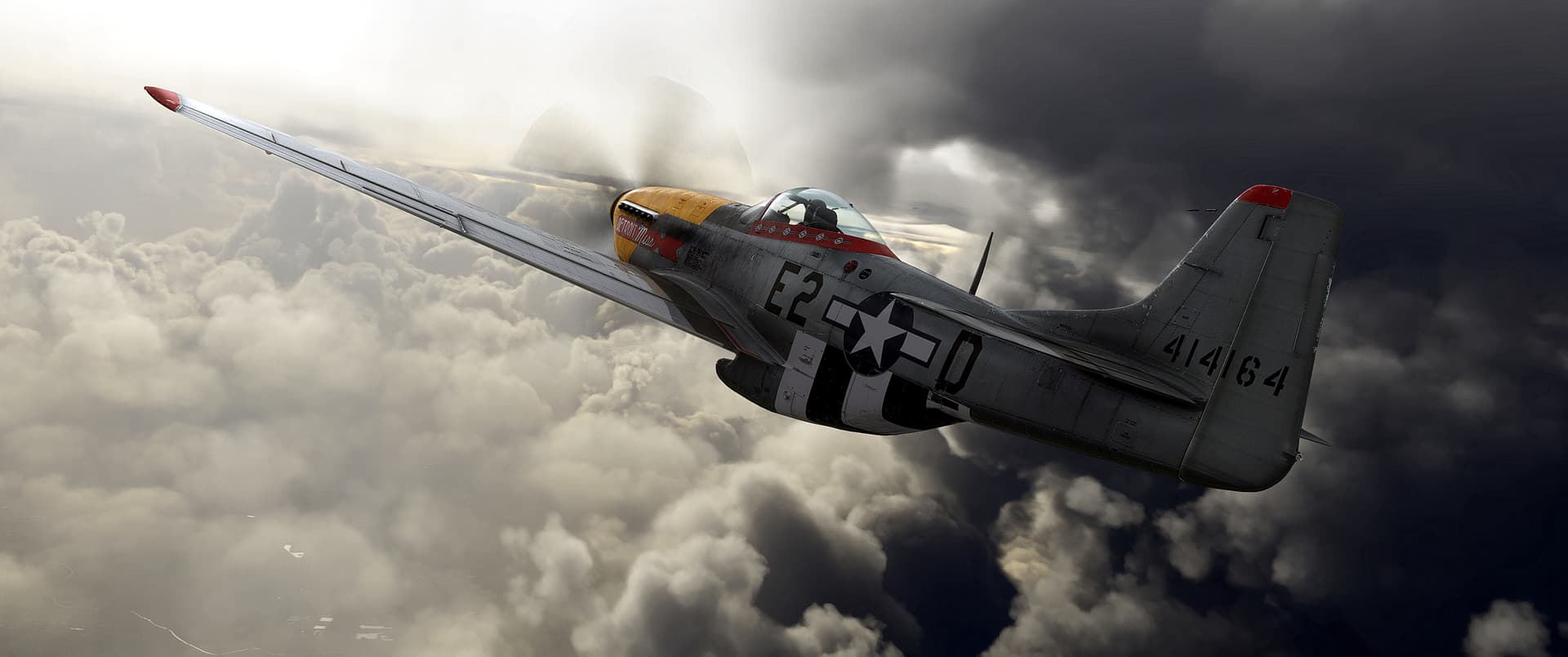 A P-51 Mustang flies in between stormy clouds