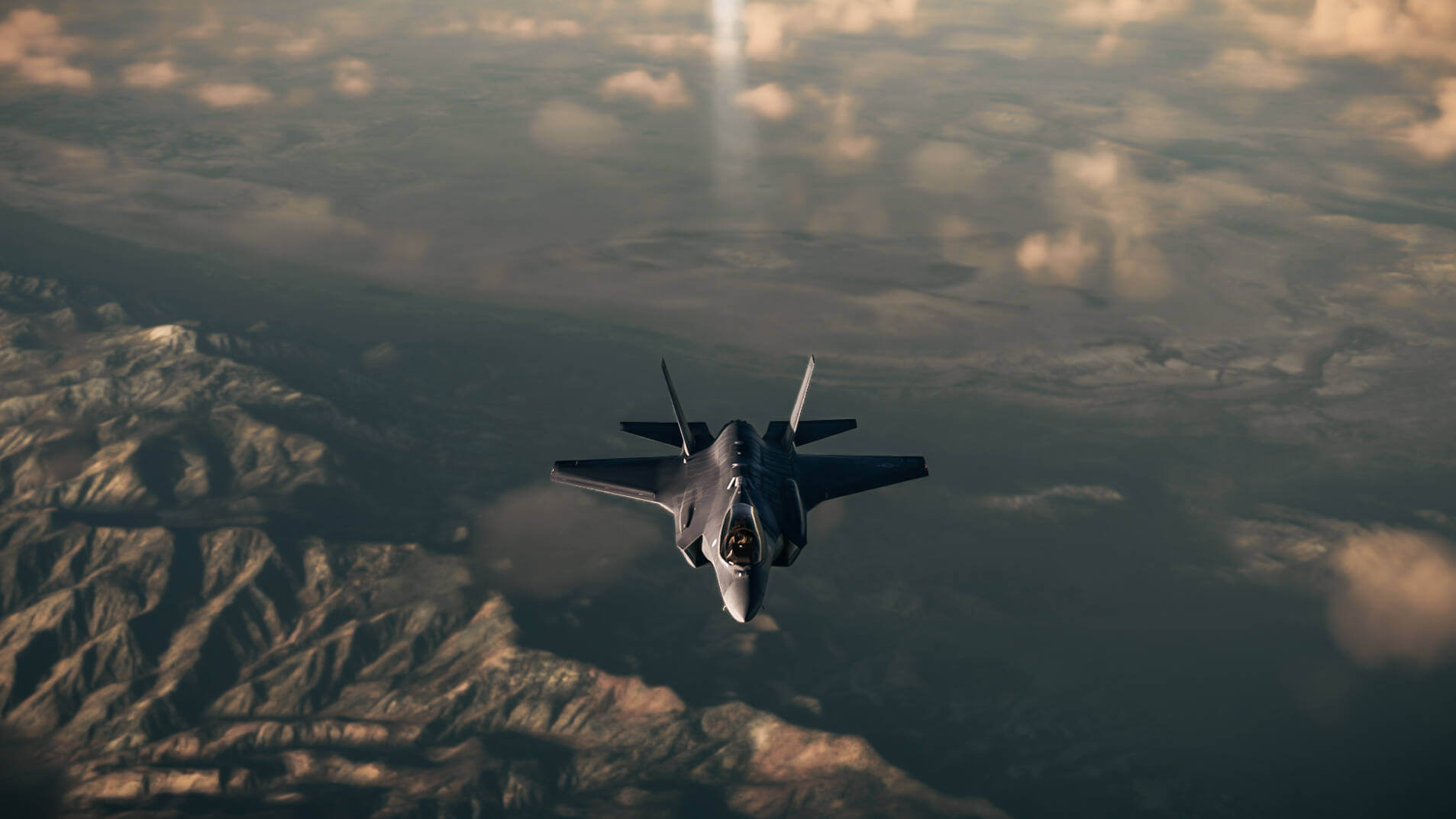An F-35 trails vapour in the sky whilst cruising at high altitude.