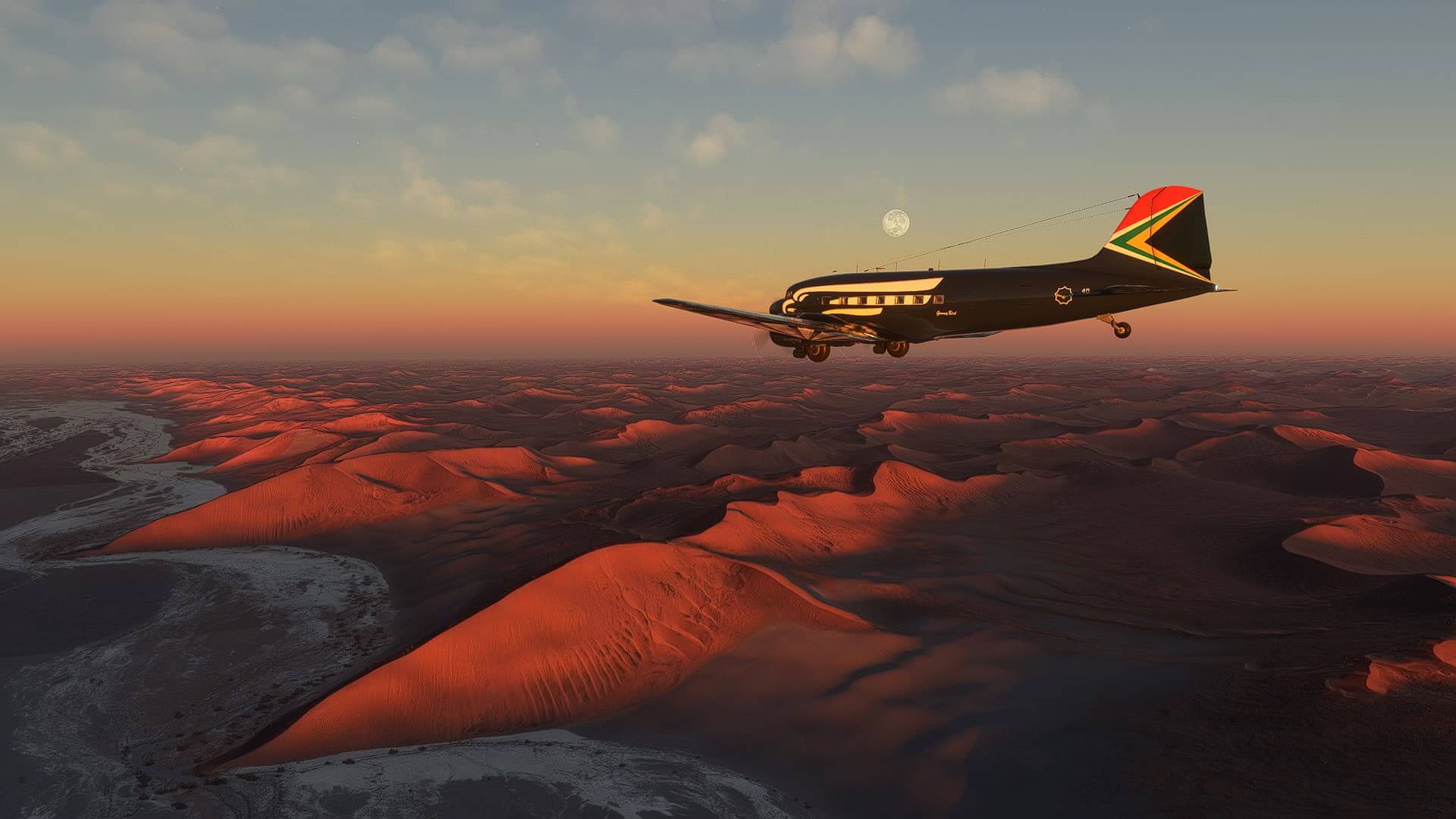 A DC-3 cruises high above sandy dunes with the sunset casting light on the fuselage.