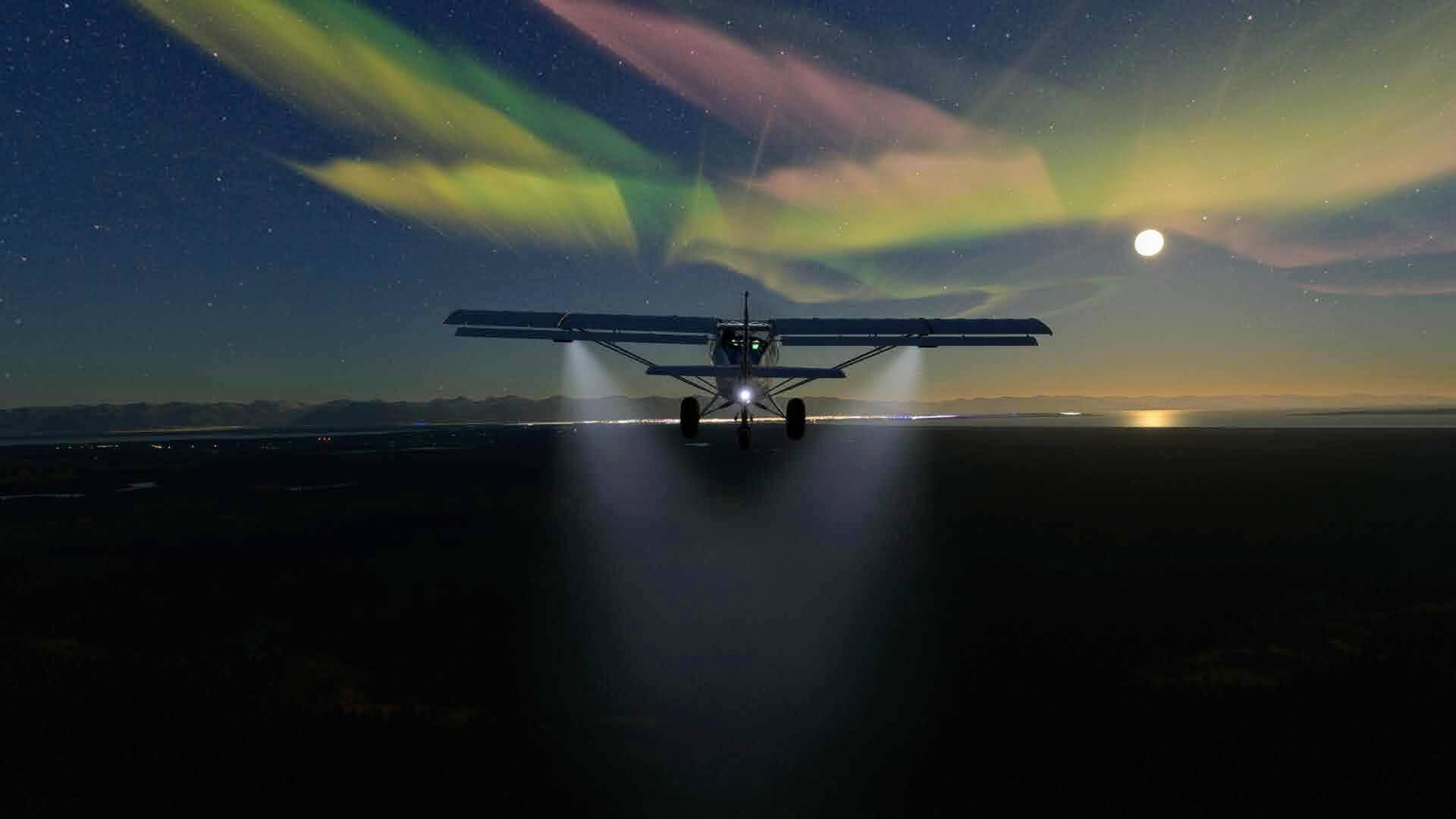An X Cub with landing lights illuminating the ground and the Aurora Borealis lighting up the sky above.