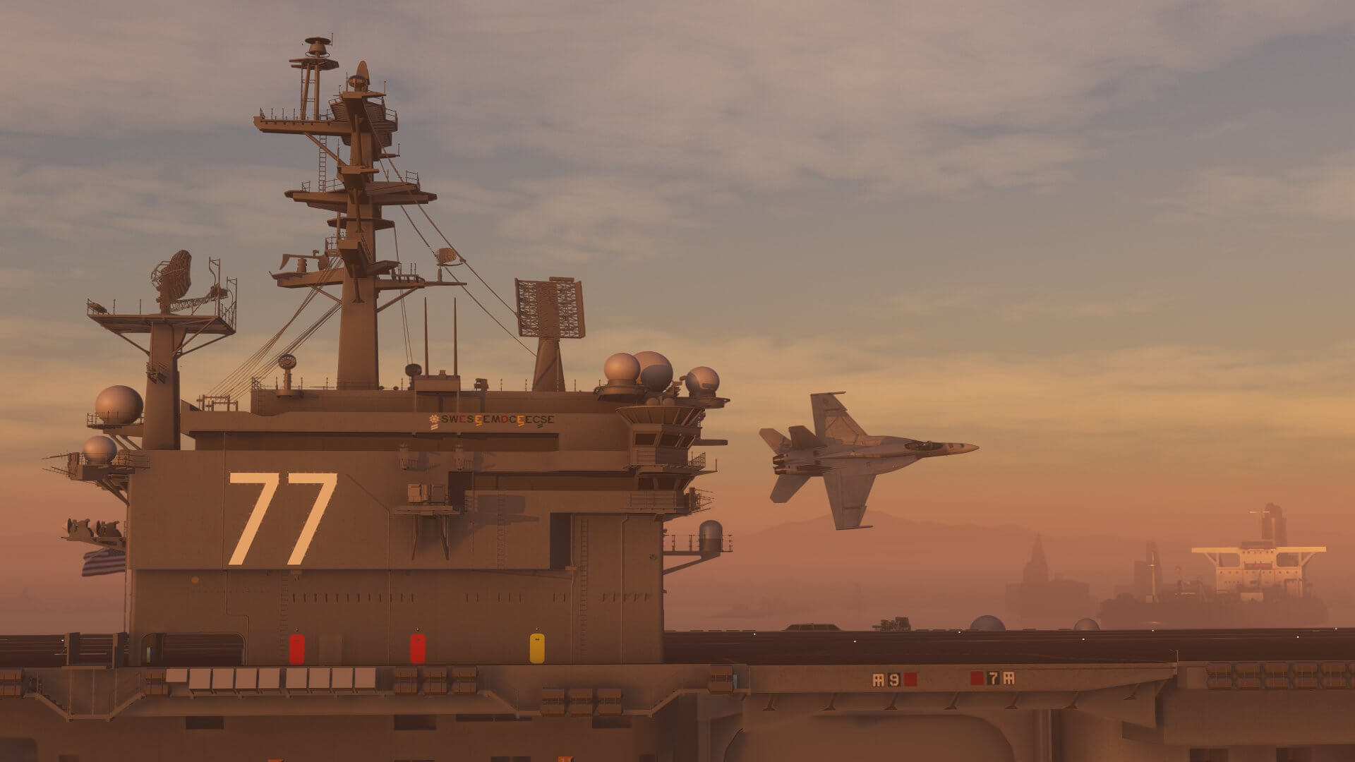 An F/A-18 Hornet flies low passed an aircraft carrier.