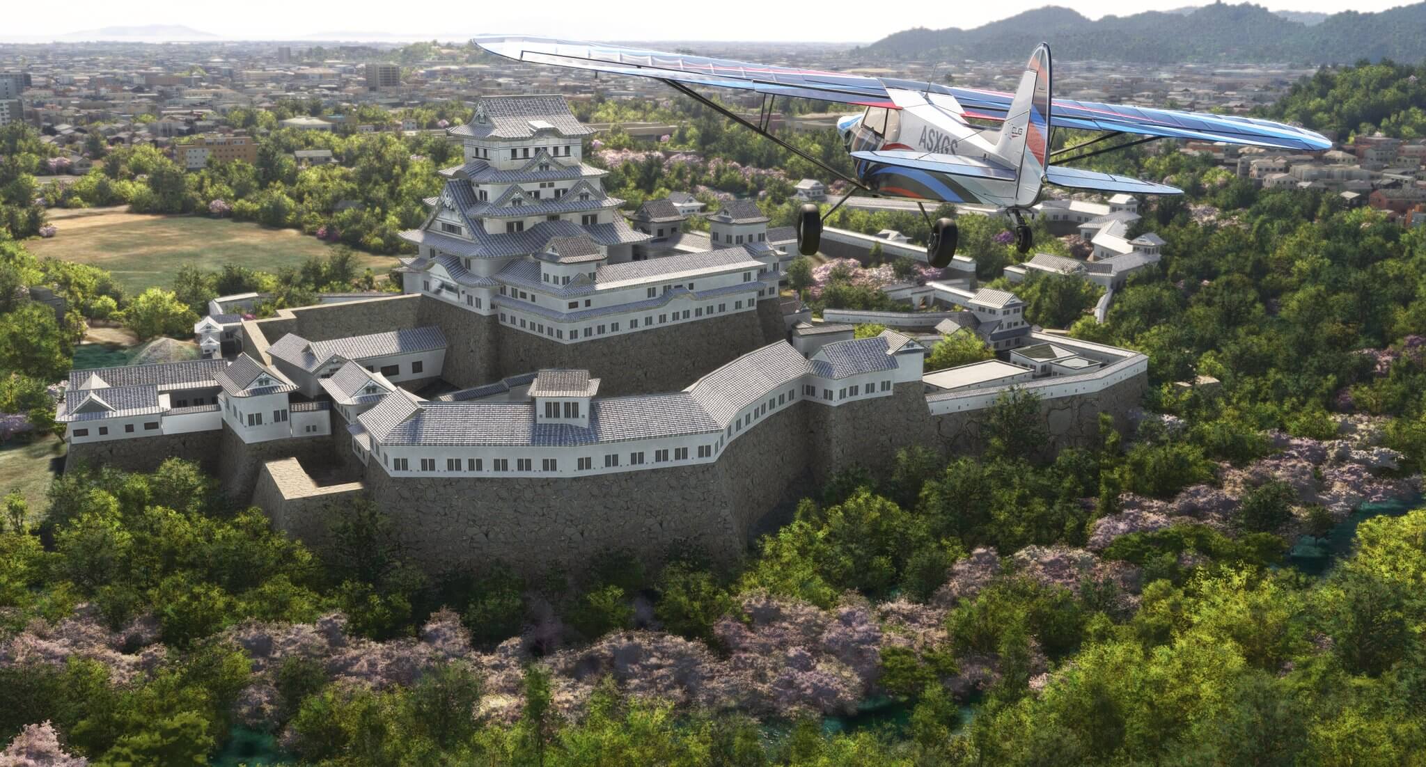 A Cub propeller aircraft flies near a castle with different colored trees and shrubbery below.