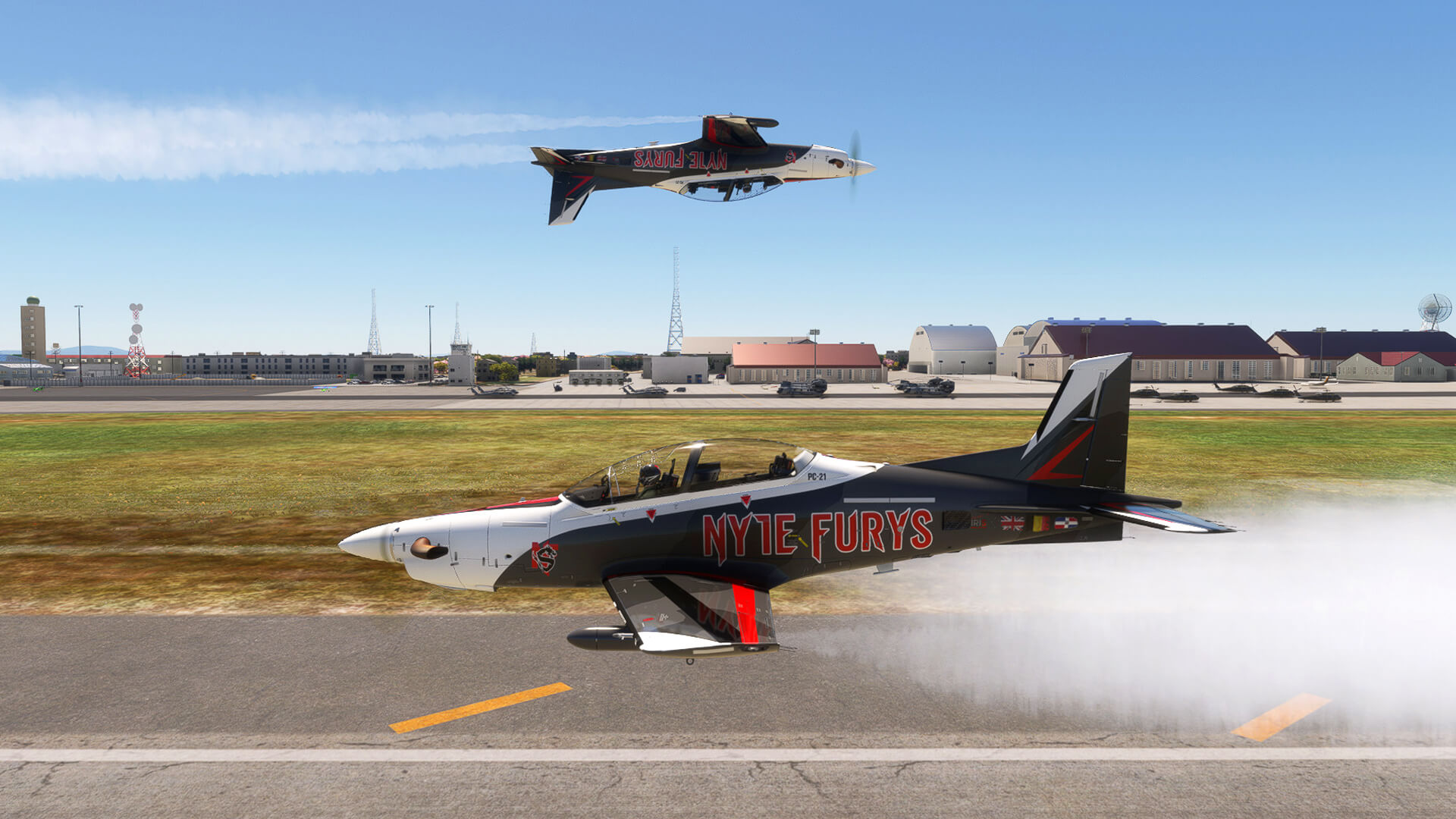 Two acrobatic aircraft in "Nyte Furys" livery pass each other with smoke on, with one inverted.
