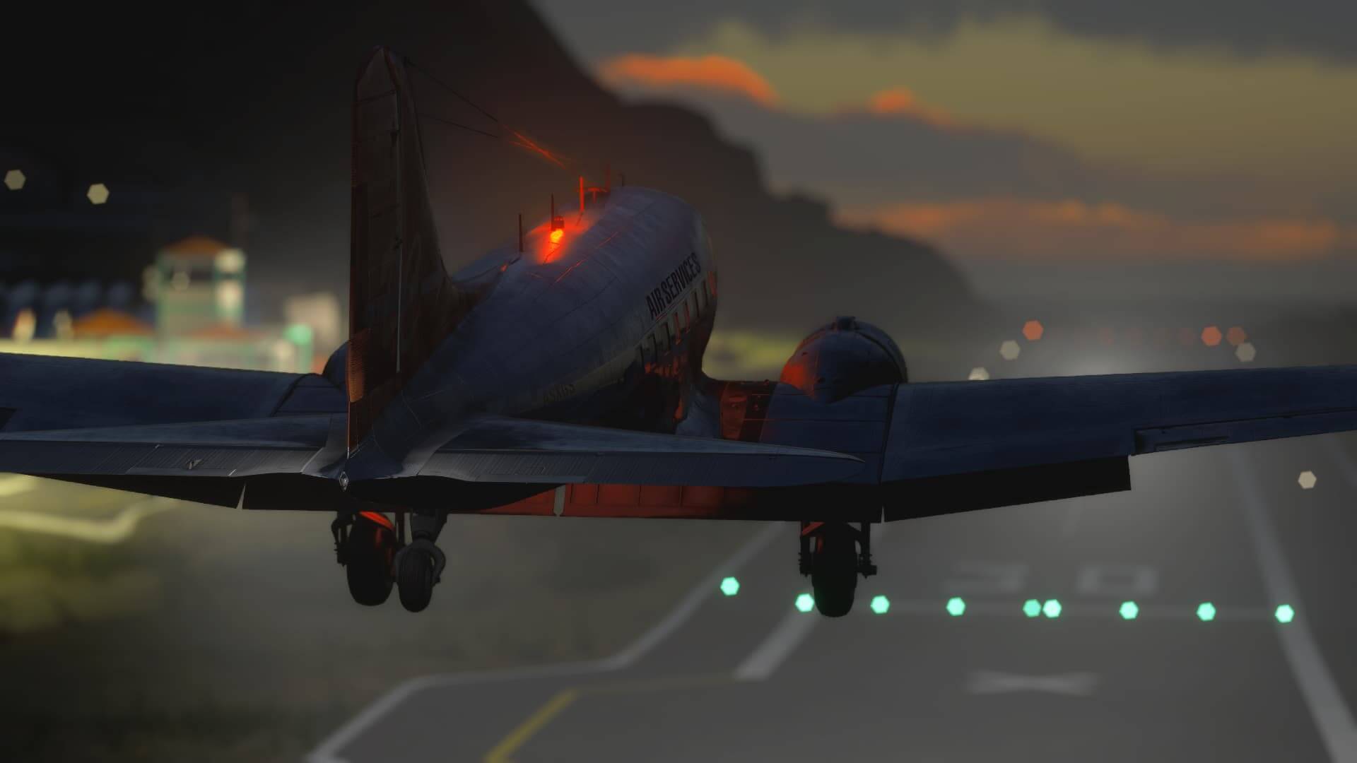 A DC-3 with beacon light flashing passes over the threshold of runway 30 at Saba airport.