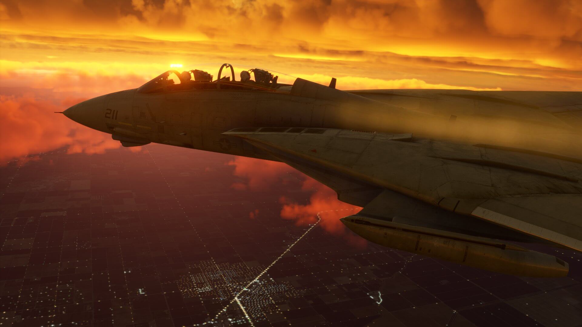 An F-14 Tomcat flies below low overcast clouds at golden hour, with the sun visible off of the right hand side of the jet, and city lights illuminated below.