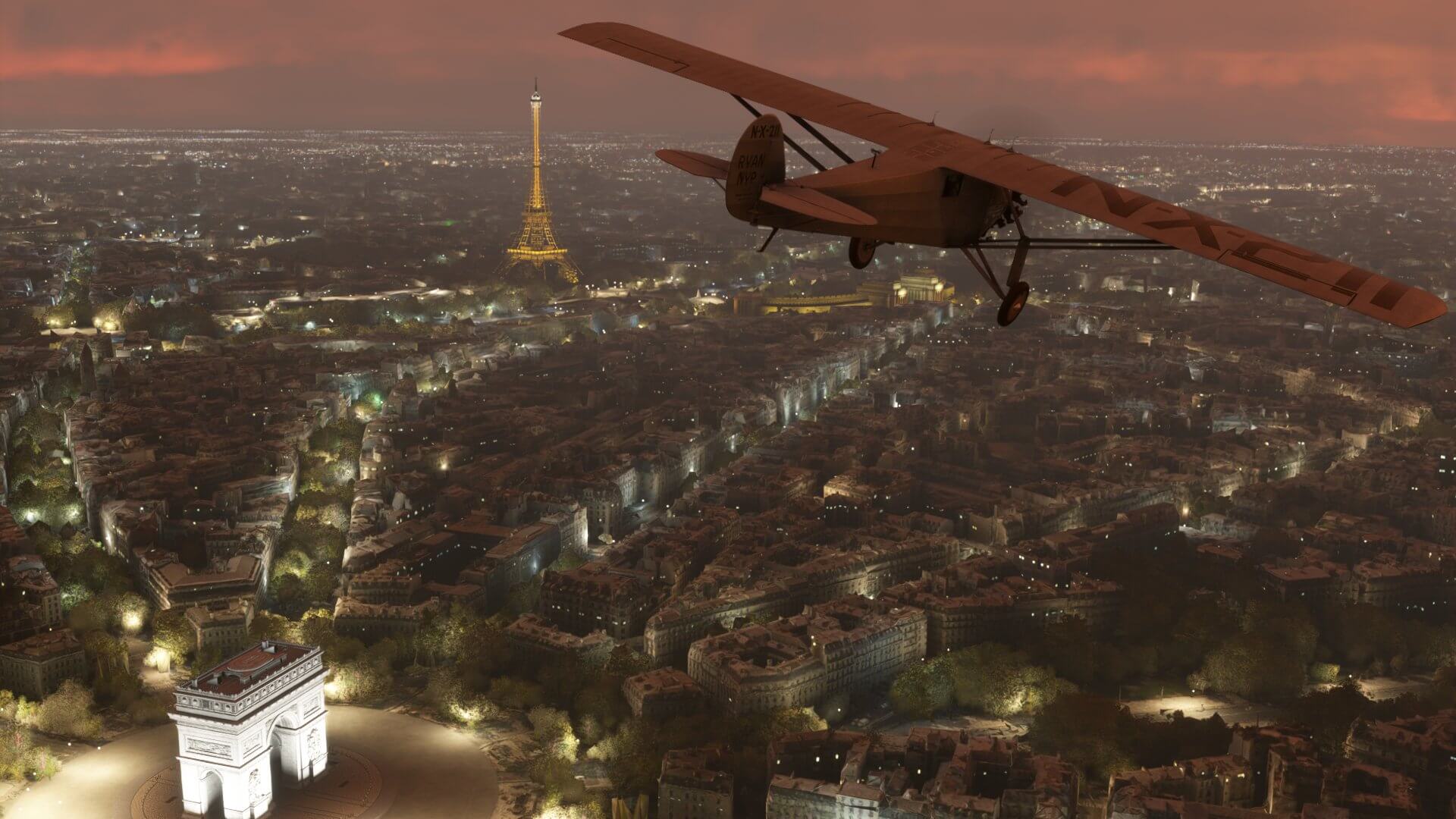 The Spirit of St. Louis aircraft banks right whilst flying low over Paris, France. The Eiffel Tower and Arc de Triomphe are lit up nearby.