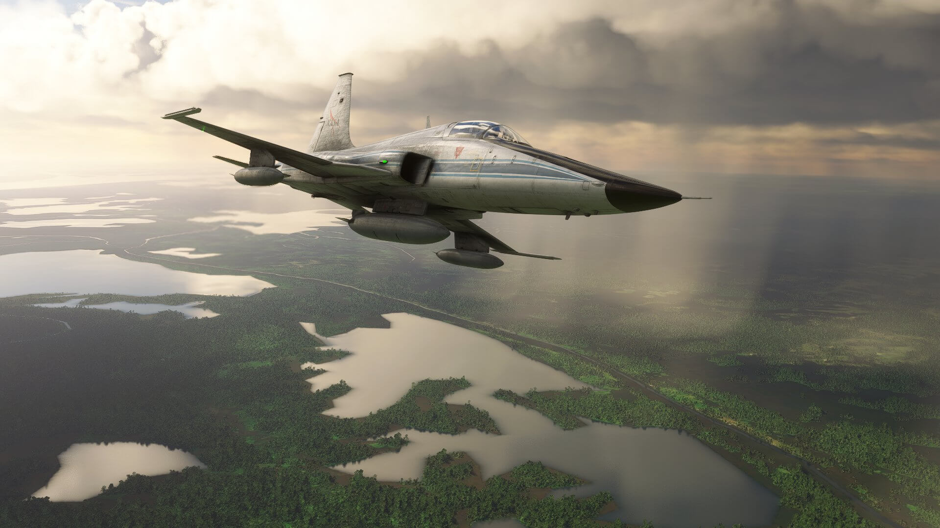 An F-5 avoids rain showers with marshland and dense vegetation below