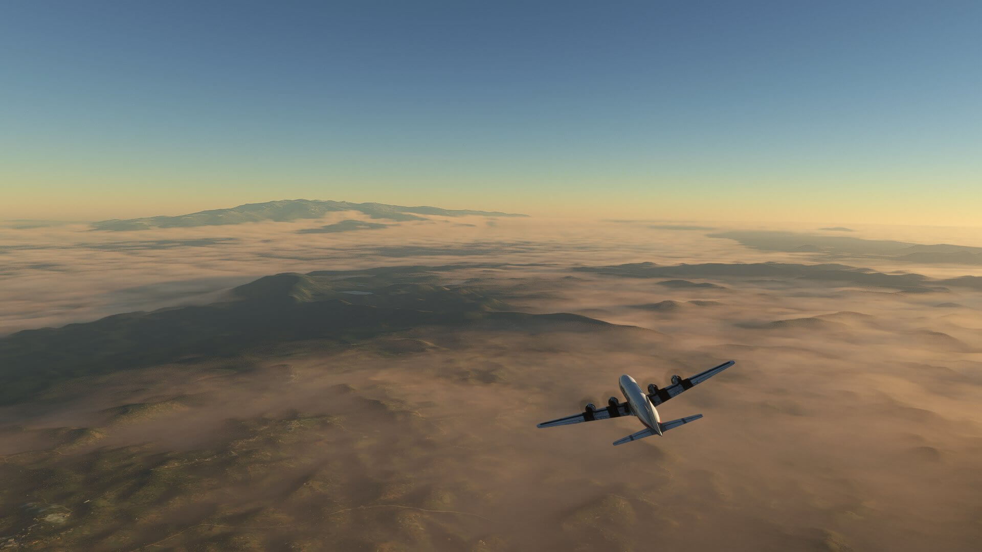 A DC-6 banks left as it cruises above low cloud layers near mountain ranges