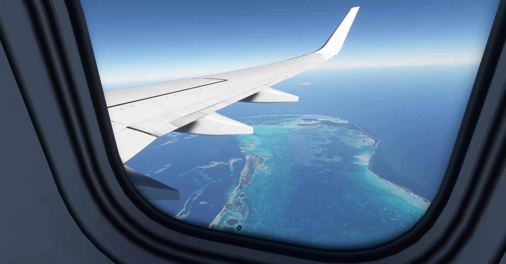 The perspective of a passenger looking out of a window of a Boeing 737 passenger airline. Outside the window the wing of the aircraft is in view, with coral reefs below.