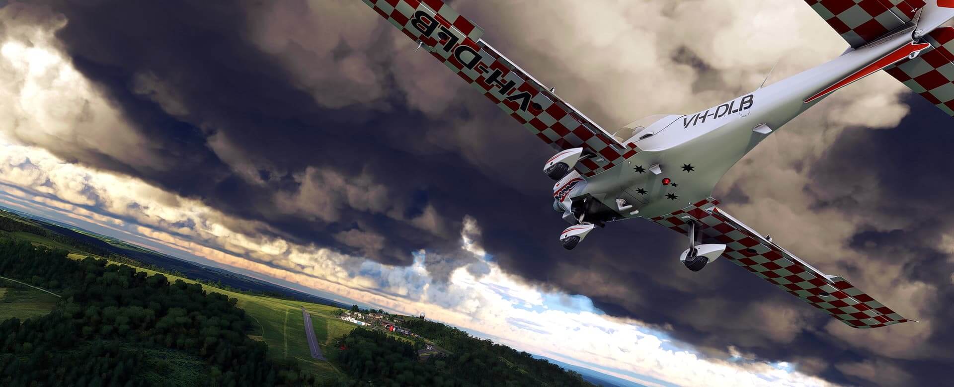 A low wing propeller aircraft in white and red checkerboard livery flies towards a thin runway, with trees either side. Above are grey and black storm clouds.
