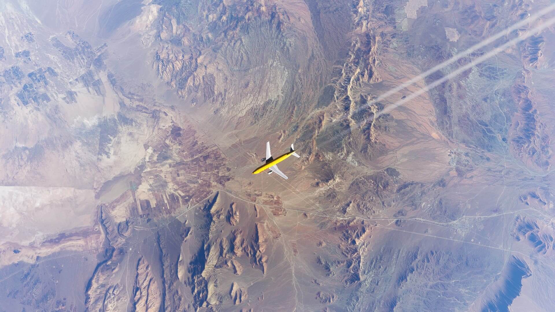 A DHL Airbus A300 cruises with contrails streaming behind over a barren desert landscape