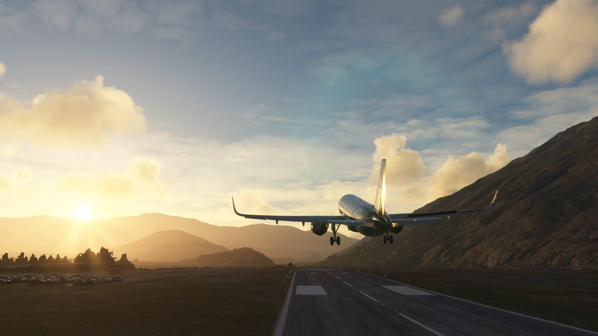 An Airbus A320 NEO takes off from Queenstown, New Zealand, with the sun in view over the mountains in the distance.