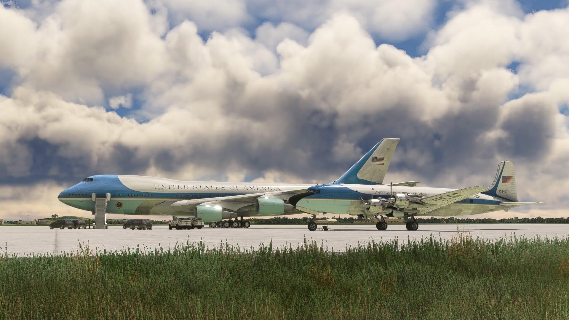 The VC-25 and DC-6 Air Force One aircraft lined up on an apron next to each other