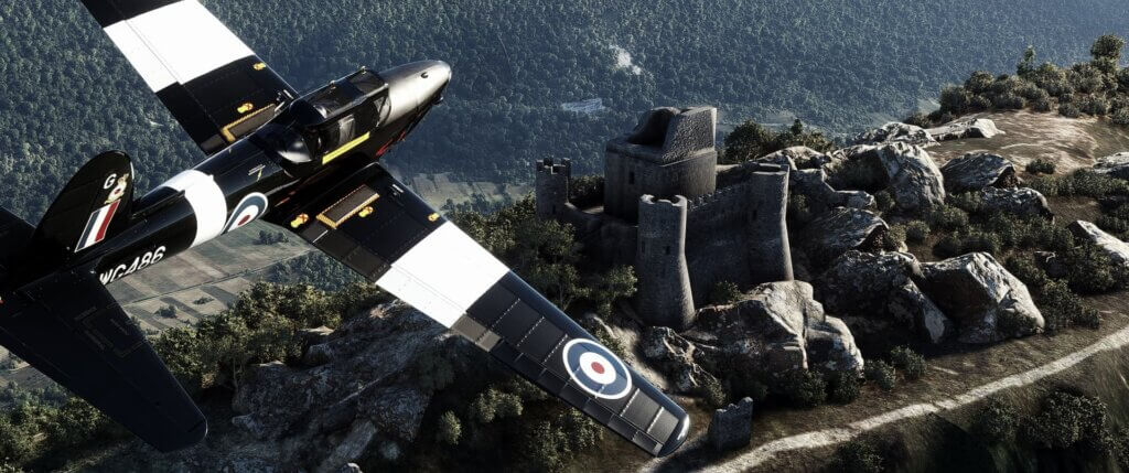 A black and white painted low wing propeller aircraft banks right away from an abandoned castle on a rocky hilltop